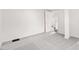 This empty bedroom features grey carpet and white walls with a door at 2321 W 26Th St, Anderson, IN 46016