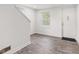 Bright entryway featuring modern gray flooring, white walls, and a staircase at 2321 W 26Th St, Anderson, IN 46016