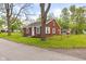 Brick house with green grass, showcasing a simple design with updated windows at 2321 W 26Th St, Anderson, IN 46016