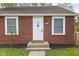 Inviting front entrance with a classic white door, brick facade, and landscaped details at 2321 W 26Th St, Anderson, IN 46016