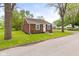 Quaint brick home showcasing green lawn, trees, and inviting curb appeal on a sunny day at 2321 W 26Th St, Anderson, IN 46016