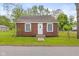 Charming brick home with a well-manicured lawn and a classic white front door at 2321 W 26Th St, Anderson, IN 46016