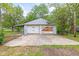 View of the garage with two doors and a concrete parking pad at 2321 W 26Th St, Anderson, IN 46016