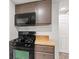 The kitchen features a black gas range, microwave, wooden countertop, and light brown cabinetry at 2321 W 26Th St, Anderson, IN 46016