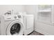 The laundry room features a white Samsung washer and LG dryer next to a window at 2321 W 26Th St, Anderson, IN 46016