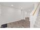 Spacious living room featuring modern flooring and staircase leading to upper level at 2321 W 26Th St, Anderson, IN 46016