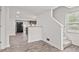 Open-concept living space with sleek flooring leading to a modern kitchen and stairs at 2321 W 26Th St, Anderson, IN 46016