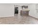 Open living area with modern flooring, black refrigerator, and partial kitchen view at 2321 W 26Th St, Anderson, IN 46016