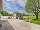 A spacious backyard has a large deck that overlooks a green field and a small gray shed at 238 Jefferson St, Pendleton, IN 46064
