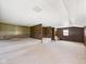 A finished basement features wood paneled walls, carpeted floors, and stairs leading up to another room at 238 Jefferson St, Pendleton, IN 46064