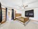 Bedroom features soft carpeting, a ceiling fan, and double doors at 238 Jefferson St, Pendleton, IN 46064