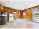 This spacious garage has wooden walls, concrete floors, and two windows letting in natural light at 238 Jefferson St, Pendleton, IN 46064