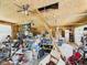 A cluttered garage with a ceiling fan has a ladder leading to a hole in the ceiling and lots of storage at 238 Jefferson St, Pendleton, IN 46064