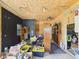A cluttered garage has a black accent wall, a ceiling fan, and lots of random objects at 238 Jefferson St, Pendleton, IN 46064
