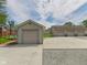 Multiple detached garages with concrete and gravel parking areas, offering ample storage and parking at 238 Jefferson St, Pendleton, IN 46064