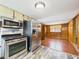 Open kitchen featuring stainless steel appliances and sleek wood paneling at 238 Jefferson St, Pendleton, IN 46064