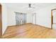 Bright, empty room with hardwood floors, a ceiling fan, and a white front door at 238 Jefferson St, Pendleton, IN 46064