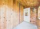 Covered patio with wooden walls, concrete flooring, and an exterior light fixture at 238 Jefferson St, Pendleton, IN 46064