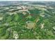 Overhead view of land parcel showing property lines, lush greenery, pond, and building sites at 2508 Indian Creek Rd, Trafalgar, IN 46181