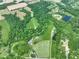 Stunning aerial view of a sprawling estate with lush greenery, a pond, and multiple buildings at 2508 Indian Creek Rd, Trafalgar, IN 46181