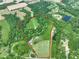 Overhead shot of land parcel showing property lines, lush greenery, pond, and building sites at 2508 Indian Creek Rd, Trafalgar, IN 46181