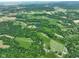 Gorgeous aerial view featuring verdant landscape with forests, fields, and small bodies of water at 2508 Indian Creek Rd, Trafalgar, IN 46181