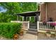 This back porch has a black gazebo, a white wooden fence, and potted flowers at 2508 Indian Creek Rd, Trafalgar, IN 46181