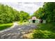 This barn on the property has a gated entrance and white perimeter fencing at 2508 Indian Creek Rd, Trafalgar, IN 46181