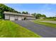 View of barn featuring multiple garage doors and a long driveway at 2508 Indian Creek Rd, Trafalgar, IN 46181