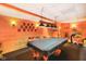 Basement game room featuring a black covered pool table, wooden walls, and decor at 2508 Indian Creek Rd, Trafalgar, IN 46181