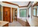 Bathroom featuring a garden tub, lots of natural light, and a toilet behind a closed door at 2508 Indian Creek Rd, Trafalgar, IN 46181