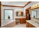 Well-lit bathroom features a garden tub, dual vanity, and tiled floors at 2508 Indian Creek Rd, Trafalgar, IN 46181