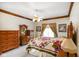 This bedroom includes a ceiling fan, natural light, decorative trim, and warm colors at 2508 W Indian Creek Rd, Trafalgar, IN 46181