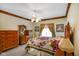Bedroom features include vintage furniture, carpeted floor, and traditional trim at 2508 Indian Creek Rd, Trafalgar, IN 46181