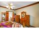 Spacious bedroom features vintage wooden furniture, carpet and access to an en-suite bathroom at 2508 Indian Creek Rd, Trafalgar, IN 46181