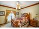 Cozy bedroom with a ceiling fan, carpet, and light-green walls with white trim at 2508 Indian Creek Rd, Trafalgar, IN 46181