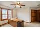 Bedroom includes natural light, carpeted floors, baseboards, and a wooden desk with drawers at 2508 W Indian Creek Rd, Trafalgar, IN 46181