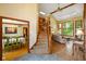 Spacious foyer showcasing a staircase, views into a dining and living room, and hardwood floors at 2508 Indian Creek Rd, Trafalgar, IN 46181