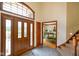 Inviting foyer featuring a beautiful front door with sidelights and views into the dining room at 2508 Indian Creek Rd, Trafalgar, IN 46181