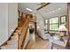Spacious foyer with wood floors, staircase, view into dining room and view into living room at 2508 Indian Creek Rd, Trafalgar, IN 46181