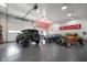 This garage features multiple classic automobiles and custom branded neon signs at 2508 Indian Creek Rd, Trafalgar, IN 46181