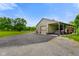The home's garage features very large door openings and an expansive apron at 2508 Indian Creek Rd, Trafalgar, IN 46181