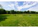 Lush green field with fencing and gates, offering ample space and scenic views at 2508 Indian Creek Rd, Trafalgar, IN 46181