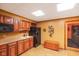 Charming kitchen with wooden cabinets, countertop sink, and black appliances at 2508 Indian Creek Rd, Trafalgar, IN 46181