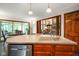 Kitchen island and sink with stainless dishwasher and view into breakfast nook and living area at 2508 Indian Creek Rd, Trafalgar, IN 46181