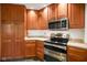 Well-equipped kitchen features stainless steel appliances, ample wood cabinetry, and great countertop space at 2508 W Indian Creek Rd, Trafalgar, IN 46181