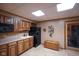 Basement kitchenette with tile flooring, wooden cabinets, black appliances, and a decorative wine rack at 2508 Indian Creek Rd, Trafalgar, IN 46181