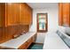 Laundry room with wooden cabinets, countertops, window, washer, and dryer at 2508 Indian Creek Rd, Trafalgar, IN 46181