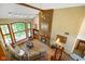 Bright living room boasts large windows, a brick fireplace, and hardwood floors at 2508 Indian Creek Rd, Trafalgar, IN 46181
