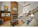 Bright living room with vaulted ceiling, brick fireplace, hardwood floors, and view into foyer at 2508 Indian Creek Rd, Trafalgar, IN 46181